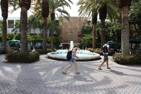 student walking in front of merrick fountain
